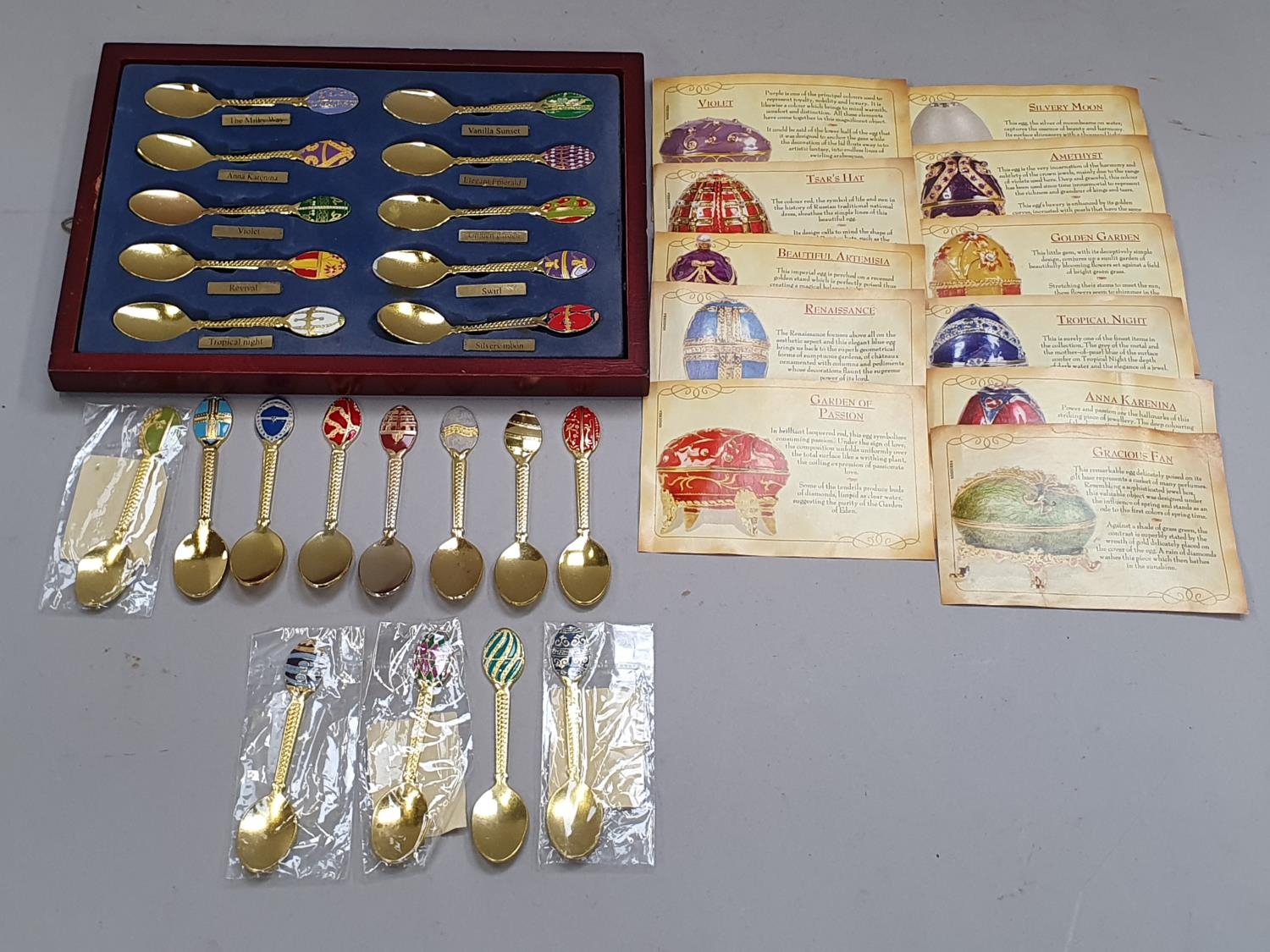 A large collection of Atlas History of Faberge eggs spoons.