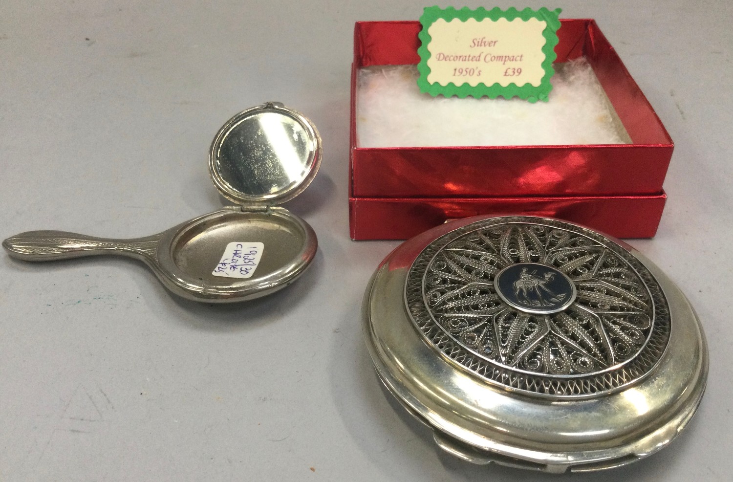 Ladies vintage 1950s silver powder compact boxed together with a small novelty powder compact in the