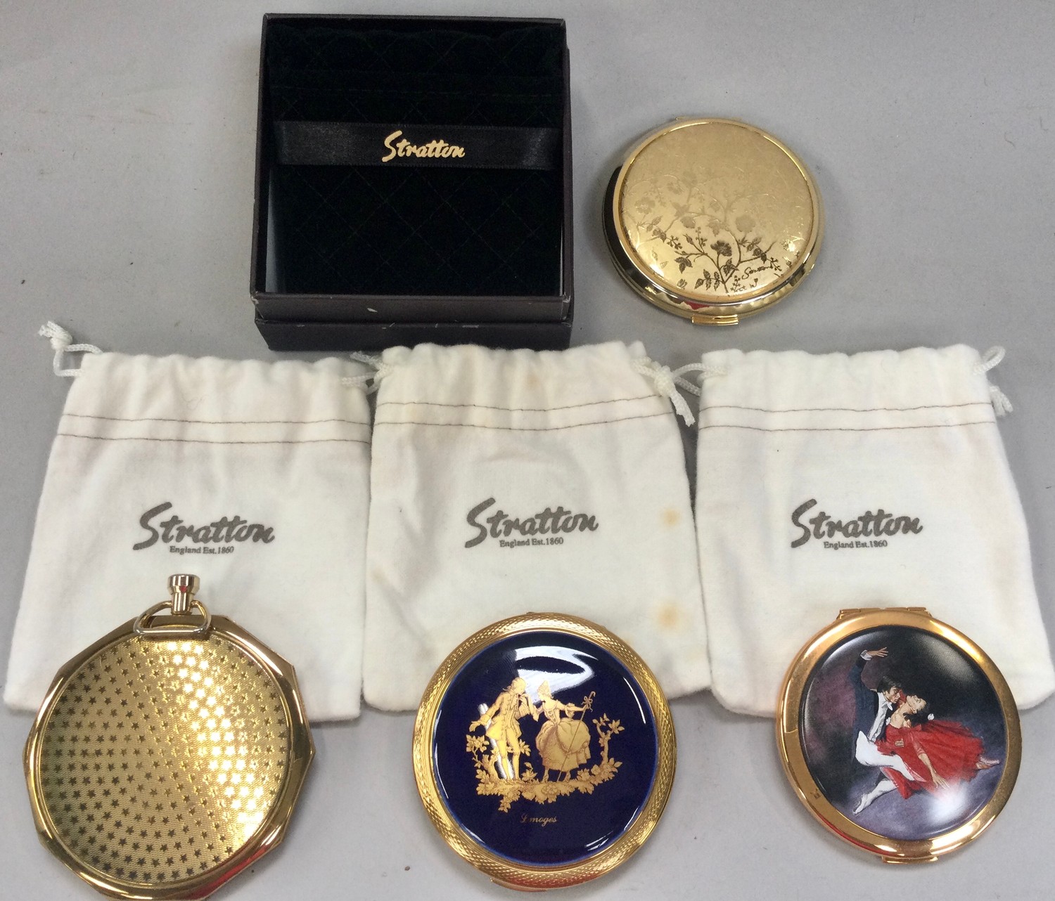 Stratton ladies compacts x4, three with cloth bags and one boxed.