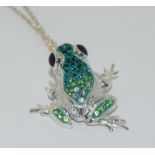 An unusual silver and coloured CZ frog pendant necklace.