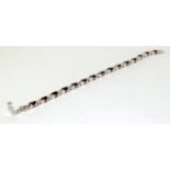 A silver CZ and Tourmaline line bracelet.