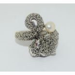 A silver panther Cartier style panther ring set with marcasites and pearl drop.