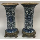 Pair of Chinese blue and white Vases with gilt rims on a gilt stand with paw feet