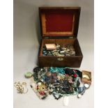 Wooden box containing a large quantity of costume jewellery to include gold and silver.