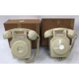 Two vintage boxed wall telephones.