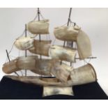 Decorative horn sculpture of a sailing boat fitted with a music box 35cm tall.