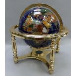 World globe with inlay semi precious stones and gold thread. Weighted rotating globe