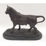 Cold painted bronze statue of a bull on base.
