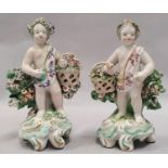 Pair of 18th Century Denby porcelain figures of Putto carrying baskets of flowers.