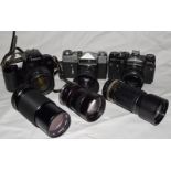 Collection of vintage 35mm flim SLR cameras and associated lenses.