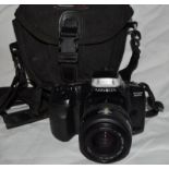 Minolta Dynax 300si 35mm film slr camer with fitted AF 35-70 zoom lens in kit bag.