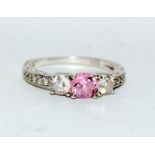 A three stone ring with CZ and pink gemstone to centre,size M REF (DR11)