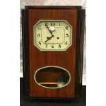Wooden framed striking pendulum wall clock