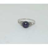 Silver ladies ring set with round pearl mount. Size O.