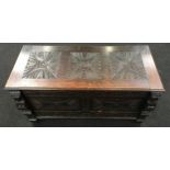 An antique oak intricatley carved wood coffer 106x45x55cm.