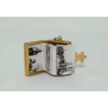 9ct gold charm depicting a book with photos inside total weight 9gm