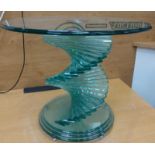 A tempered glass designer lamp table on twisted support 50cm x 60cm.