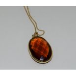 Gold amber quartz pendant necklace.