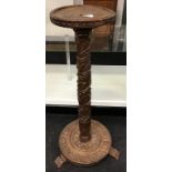 Finely carved lamp table or small torcher set on single round base with carved feet 80cm tall