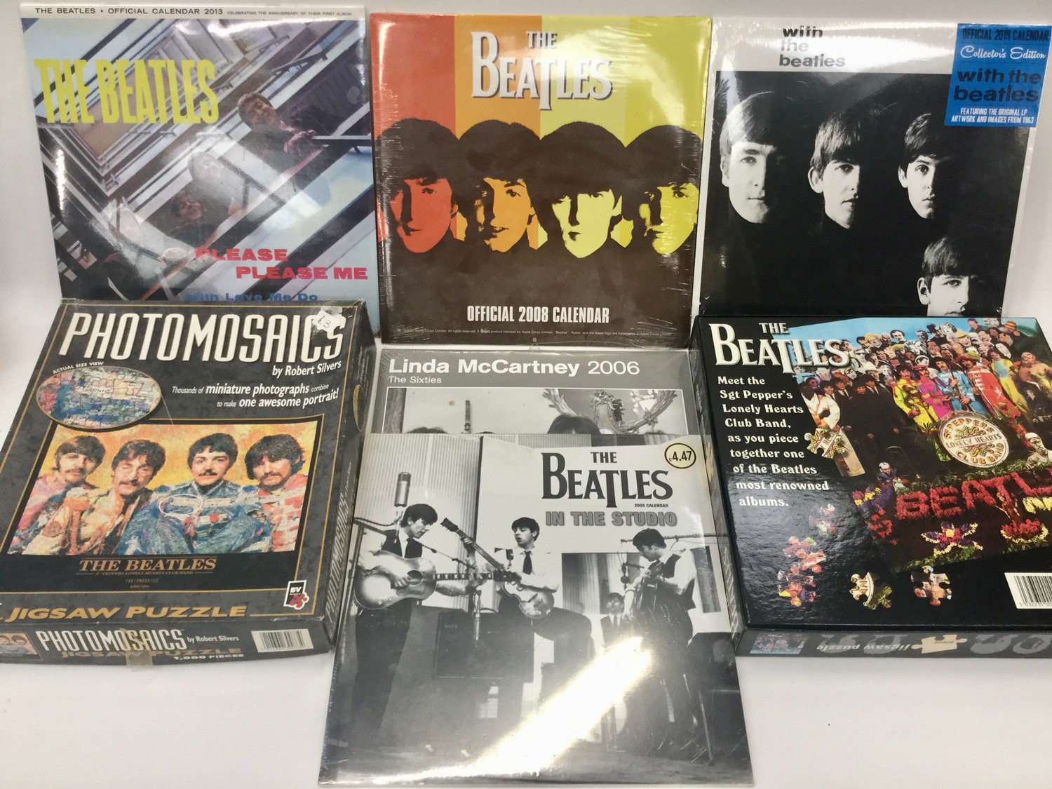 BEATLES PUZZLES AND CALENDARS. 2 puzzles in this lot along with 4 sealed Beatles calendars from