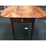 Mahogany Pembroke table with fitted draw on tapered supports with fitted brass casters and rounded