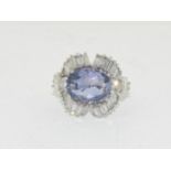 Substantial platinum ring with central sapphire of approx 5.6ct surrounded by diamonds size O