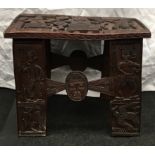 A dark wood possibly Indonesian carved occasional table 51x36x39cm.
