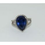 Silver ladies blue stone pear shape ring. Size K.