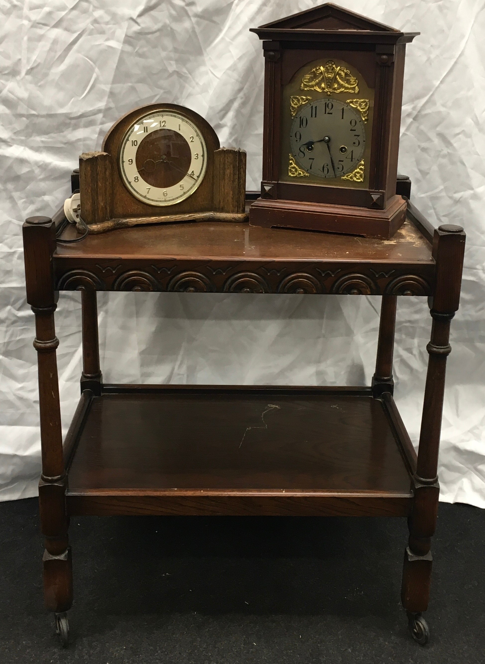 Mahogany butler's trolley on castors 63x45x73cm together with two vintage clocks.