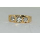 An 18ct yellow gold gents three stone diamond ring of 2cts. Size T