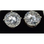 A pair of silver and CZ stud earrings 20cts approx.