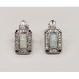 A pair of silver CZ and Opal paneled earrings.