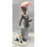 Lladro "Lady of the Shawl" walking a dog.