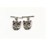 A pair of silver cat head cuff links with bar links.
