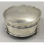A solid silver trinket box with lining, engine turned top with blank cartouche.