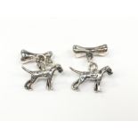 A pair of silver dog and bone cufflinks.