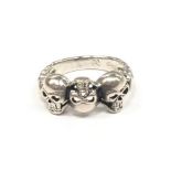 A silver scull headed ring.