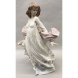 Lladro "5898" Spring Splendour girl holding a basket of flowers.