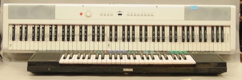 A Yamaha electronic keyboard together with a Gear4Music electronic keyboard (2).