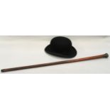 Dunn & Co. bowler hat together with a silver topped walking cane.