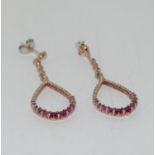 Rose gold on silver ruby and CZ drop earrings.