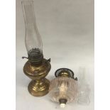 Vintage brass oil lamp with another in a vintage suitcase