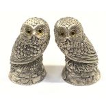 A pair of silver plated owl condiments with glass eyes.