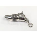 A silver horse head whistle.