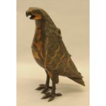 Unusual brass figure of a hawk standing 11" tall. It has a hinged cover on its back to enable it