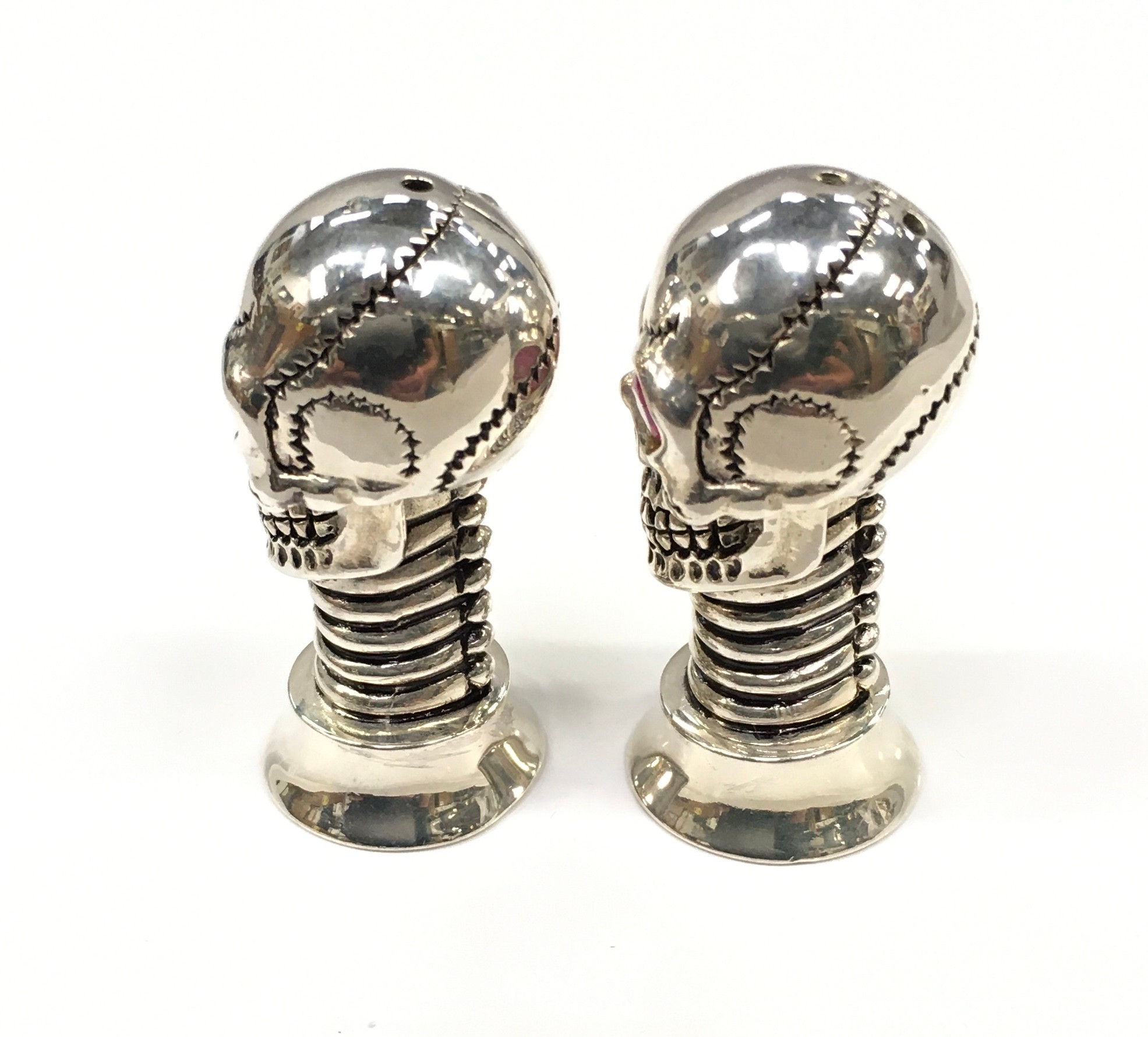 An unusual pair of silver plated scull shaped condiments with ruby eyes. - Image 2 of 4