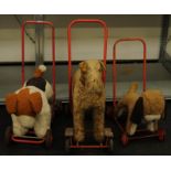 Three vintage child's push along dog toys.