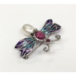 A silver bug plique a jour brooch set with rubies.