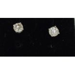 A pair of 14ct white gold diamond stud earrings of 65 points approx.