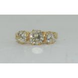 An 18ct yellow gold three stone ring of 1.8cts. Size M